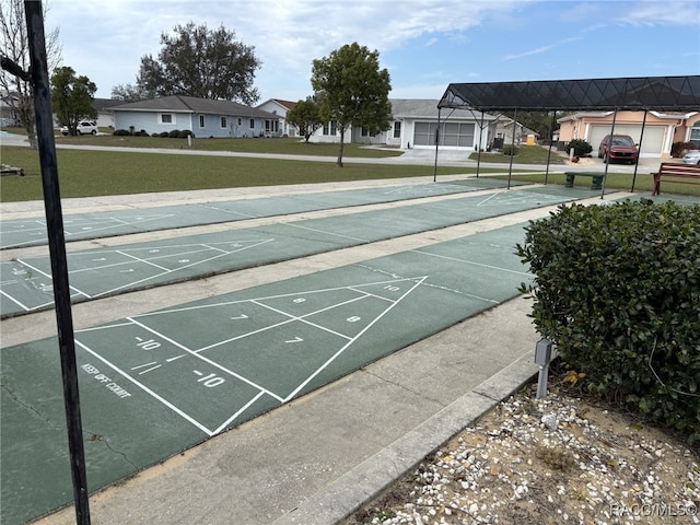 view of home's community featuring a residential view, shuffleboard, and a lawn