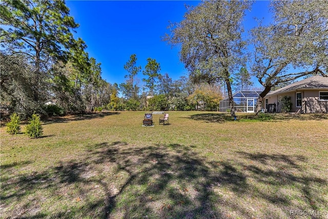 view of yard featuring a lanai