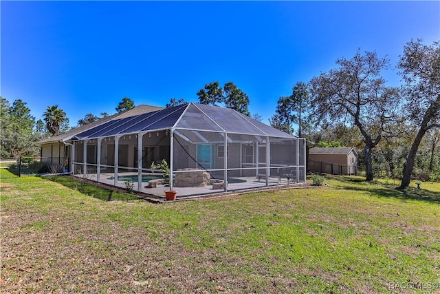 rear view of house featuring glass enclosure, a lawn, a patio, and an outdoor pool