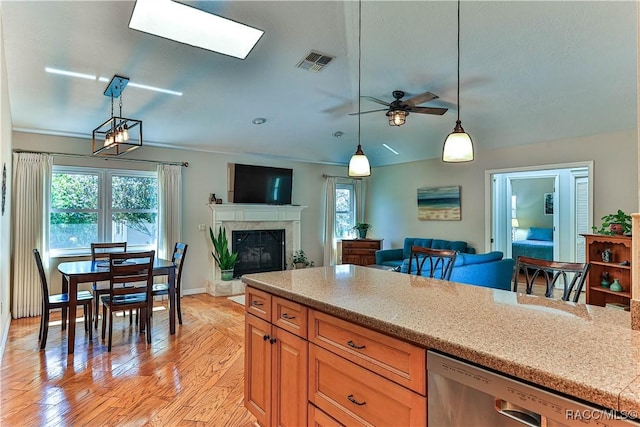 kitchen featuring open floor plan, visible vents, dishwasher, and hanging light fixtures