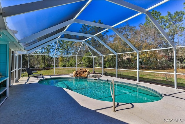 pool featuring glass enclosure and a patio