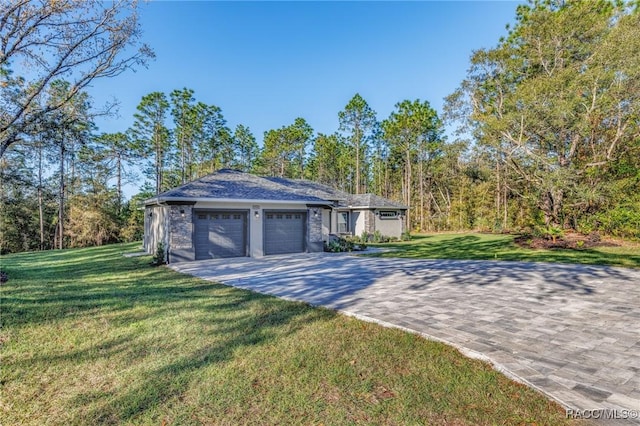 exterior space featuring a yard, an attached garage, and driveway