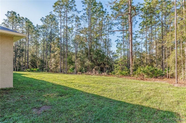 view of yard with a wooded view