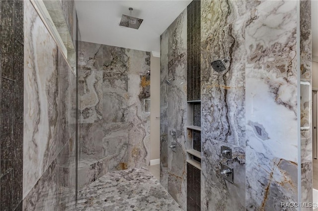 bathroom featuring a marble finish shower