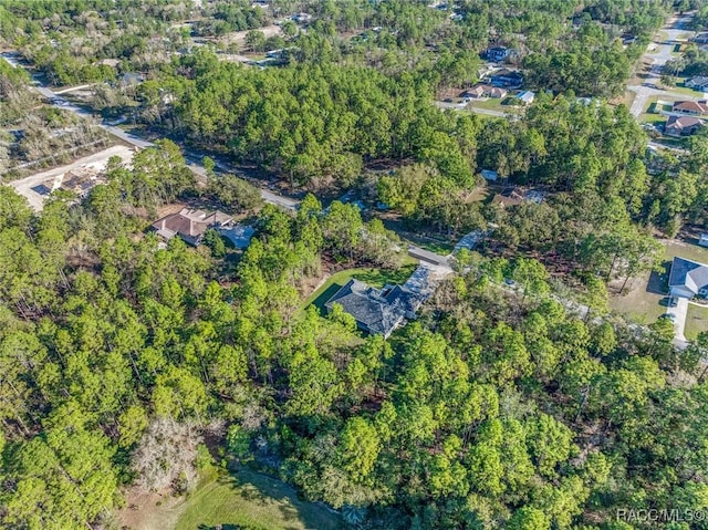 birds eye view of property with a wooded view