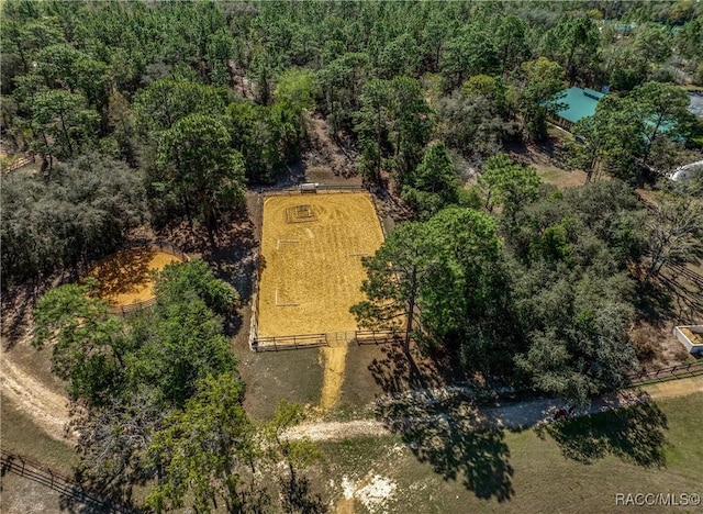 drone / aerial view featuring a wooded view