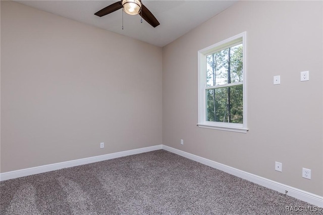 carpeted spare room with baseboards and ceiling fan