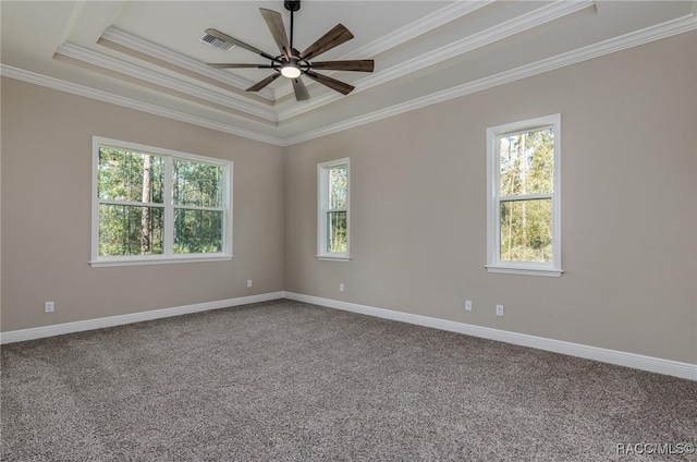 carpeted spare room featuring baseboards, plenty of natural light, and a ceiling fan