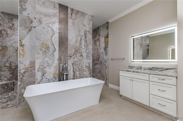 full bathroom with vanity, a freestanding tub, crown molding, tile walls, and marble finish floor