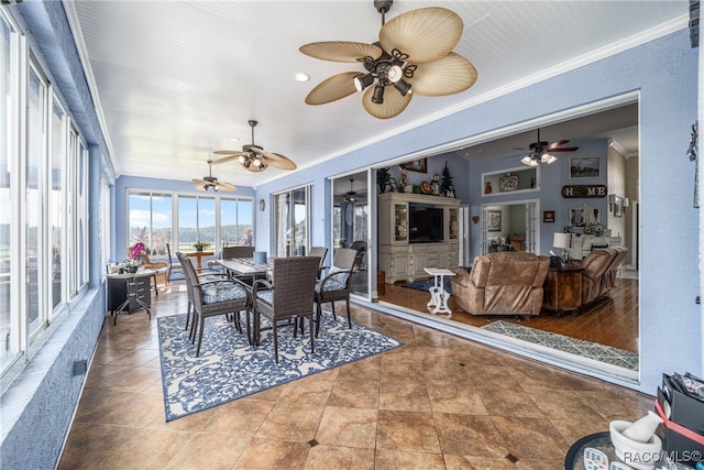 sunroom / solarium featuring ceiling fan