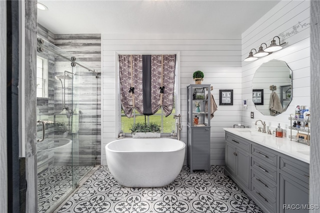 bathroom with wooden walls, vanity, and shower with separate bathtub