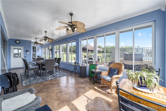 sunroom featuring ceiling fan