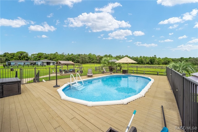 view of swimming pool with a yard and a wooden deck