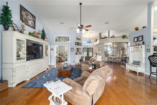 living room with a high ceiling, hardwood / wood-style flooring, and ceiling fan