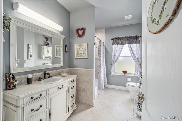 bathroom with tile patterned flooring, a shower with curtain, vanity, and toilet