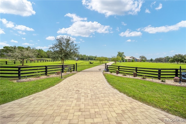 view of home's community featuring a lawn and a rural view