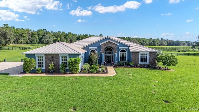 ranch-style house with a front yard and a rural view