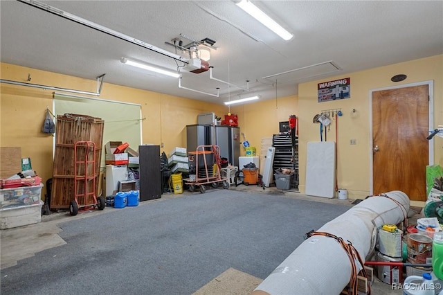 garage featuring stainless steel fridge and a garage door opener