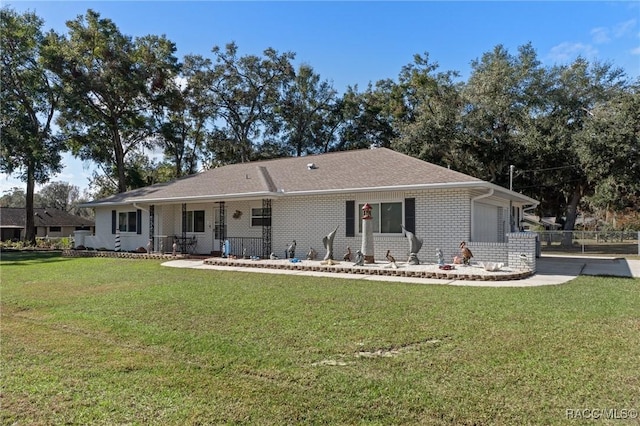 rear view of property featuring a lawn