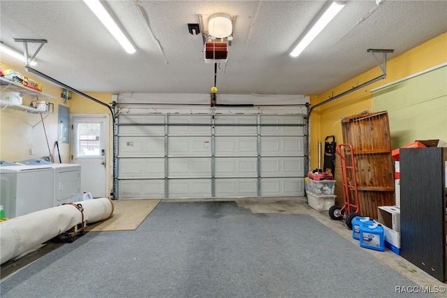 garage with washing machine and dryer, electric panel, and a garage door opener