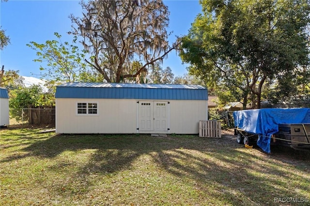 view of outdoor structure with a lawn