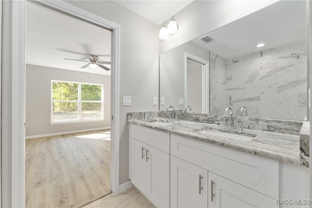 9065 N Arcadia Way, Citrus Springs, FL 34434 - bathroom with a sink, a textured wall, a ceiling fan, and visible vents