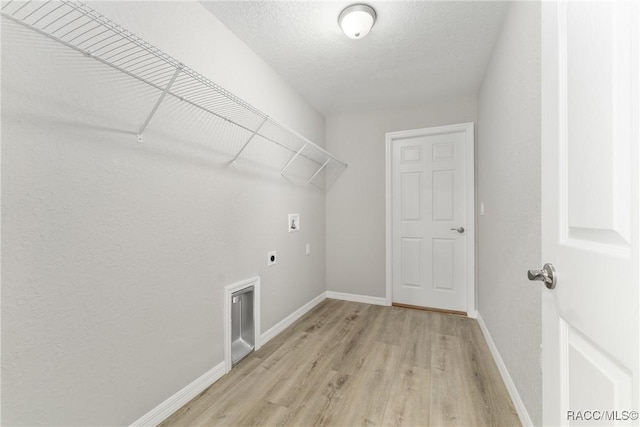 9065 N Arcadia Way, Citrus Springs, FL 34434 - clothes washing area featuring laundry area, electric dryer hookup, washer hookup, baseboards, and light wood-style floors