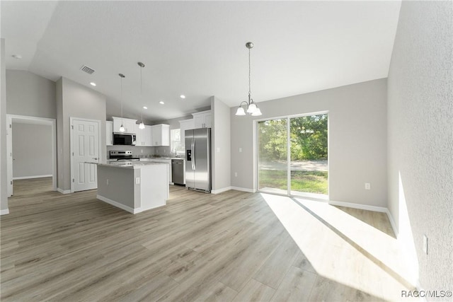 9065 N Arcadia Way, Citrus Springs, FL 34434 - kitchen featuring stainless steel appliances, visible vents, vaulted ceiling, a chandelier, and a center island