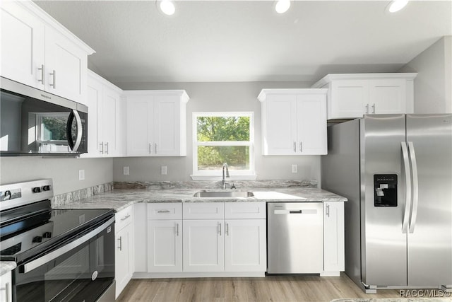 9065 N Arcadia Way, Citrus Springs, FL 34434 - kitchen featuring a sink, recessed lighting, white cabinets, and appliances with stainless steel finishes