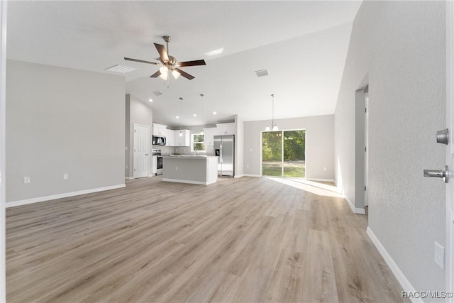 9065 N Arcadia Way, Citrus Springs, FL 34434 - unfurnished living room with high vaulted ceiling, visible vents, a ceiling fan, baseboards, and light wood-style floors