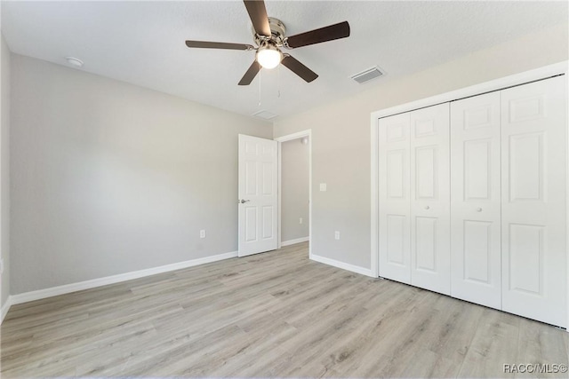 9065 N Arcadia Way, Citrus Springs, FL 34434 - unfurnished bedroom featuring wood finished floors, baseboards, a closet, and a ceiling fan