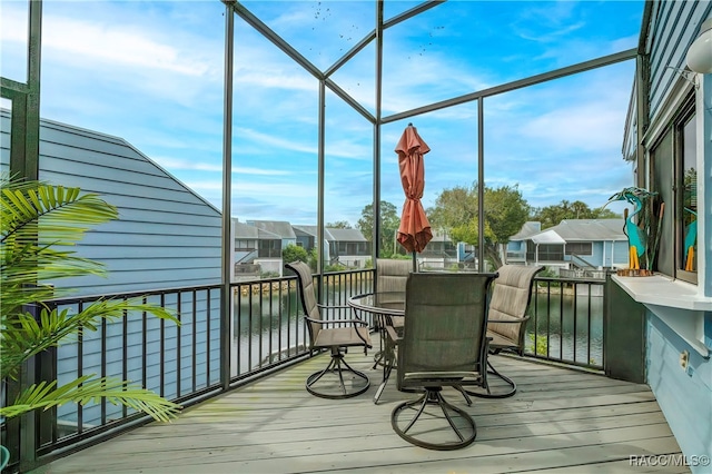 sunroom / solarium featuring a water view