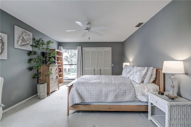 carpeted bedroom with a closet and ceiling fan