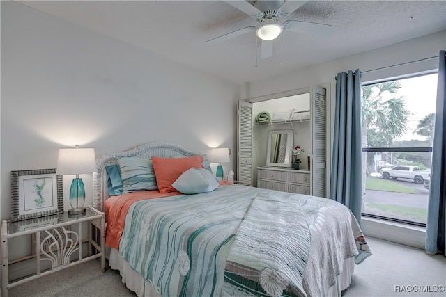 bedroom featuring light carpet and ceiling fan