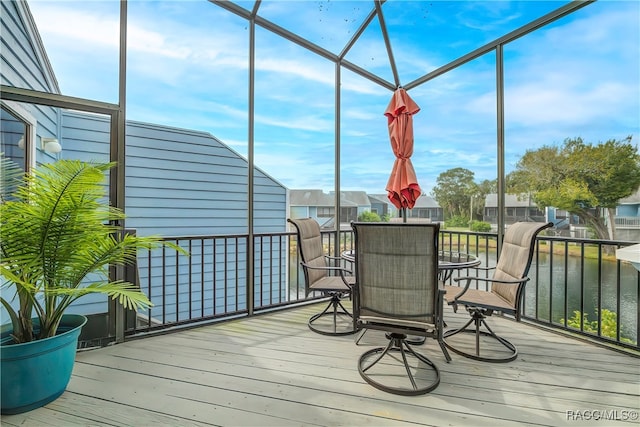 sunroom with a water view and a wealth of natural light