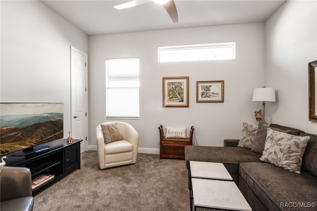 carpeted living room with ceiling fan