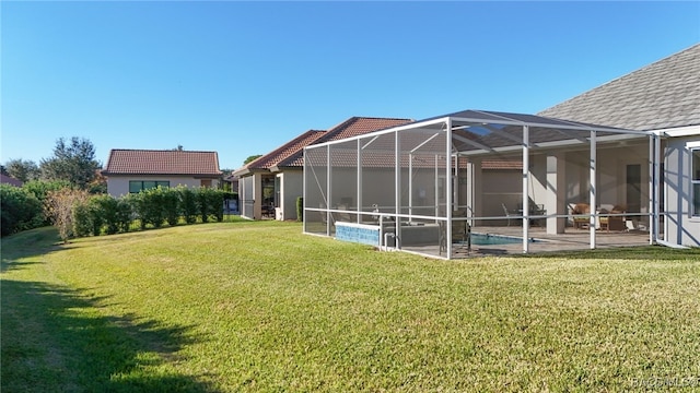 view of yard featuring glass enclosure and a patio area