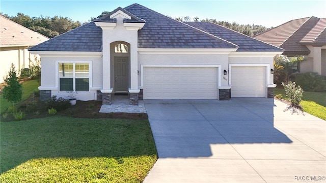 view of front facade with a front yard and a garage