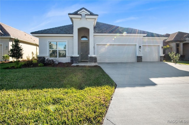 view of front of home featuring a garage and a front lawn