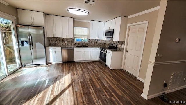 kitchen with dark hardwood / wood-style floors, white cabinetry, sink, and appliances with stainless steel finishes