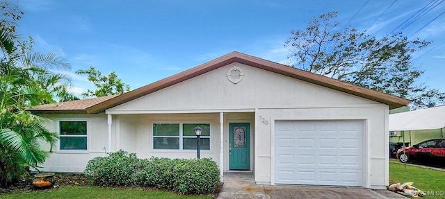 single story home with a front yard and a garage