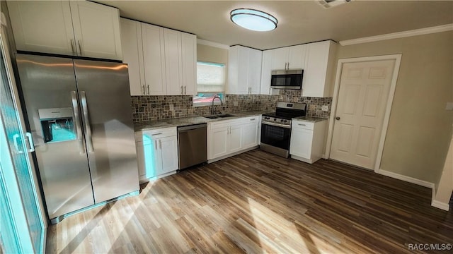 kitchen with white cabinets, appliances with stainless steel finishes, backsplash, and sink