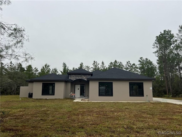 prairie-style house with a front yard and stucco siding