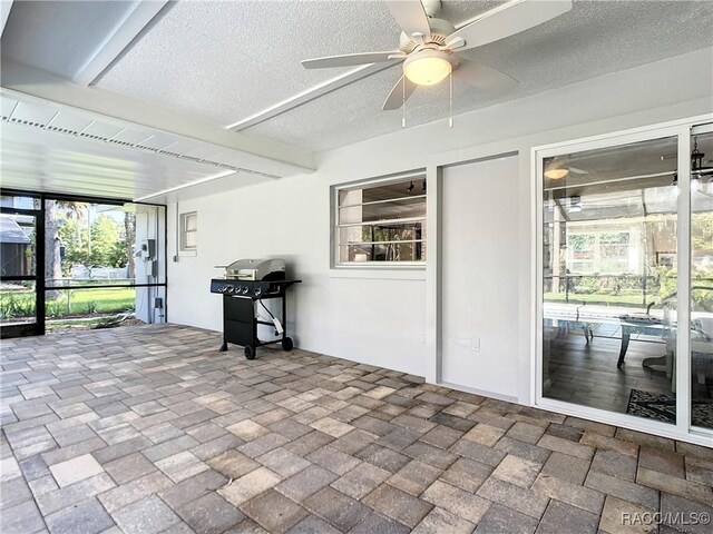 view of swimming pool featuring a grill and ceiling fan