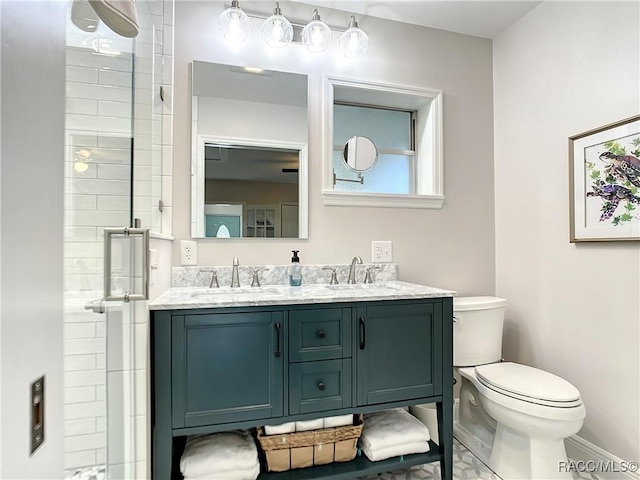 full bath with a sink, a shower stall, toilet, and double vanity