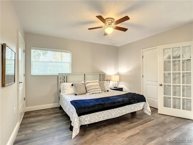 bedroom with dark hardwood / wood-style floors and ceiling fan