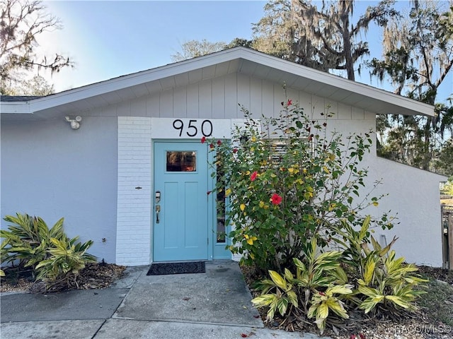 view of exterior entry featuring brick siding