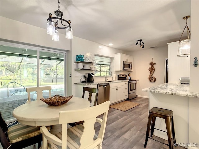 dining space with wood-type flooring and sink