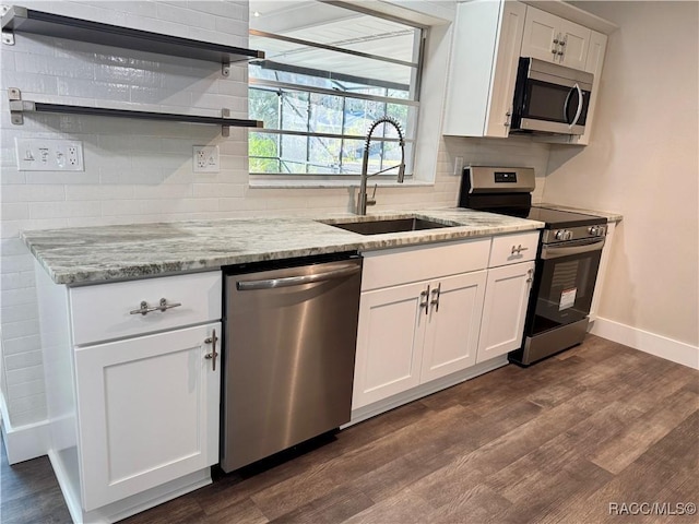 kitchen with stainless steel appliances, white cabinetry, a sink, and open shelves