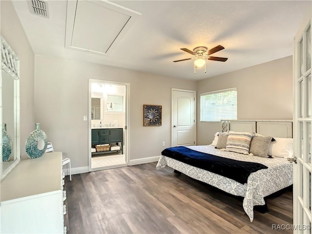 bedroom with dark hardwood / wood-style floors, connected bathroom, and ceiling fan